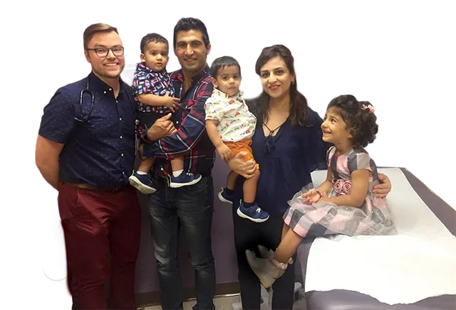 A doctor with a family and three children at Erie Family Health